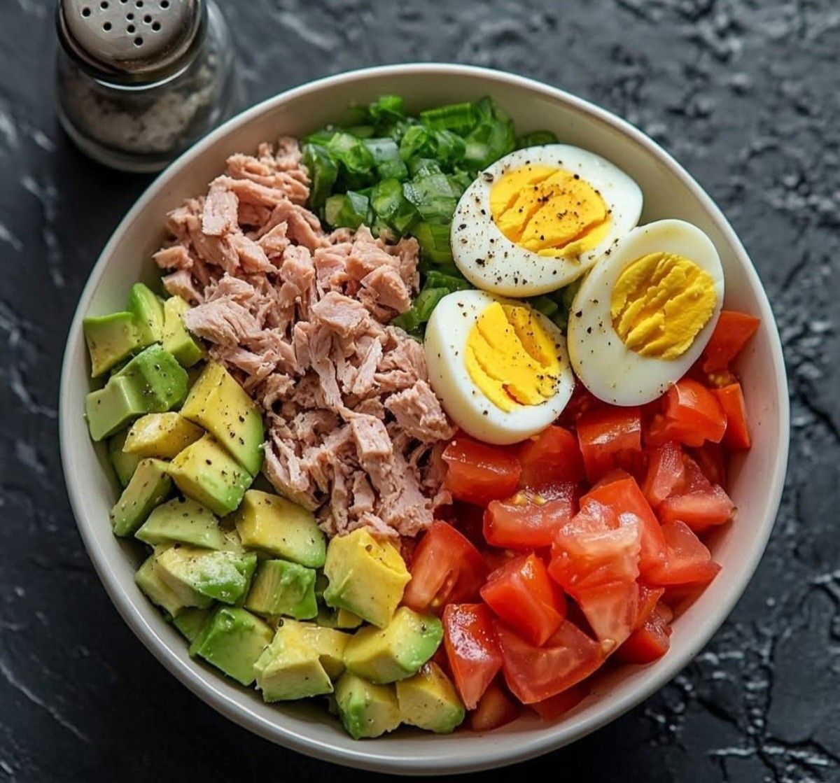Morning meal routine with herbal tea, a journal, and a bowl of fresh fruit on a sunlit table